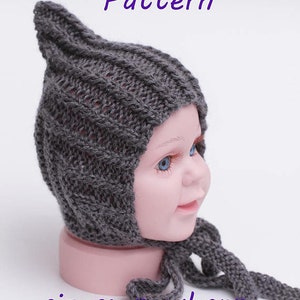 May include: A grey knitted baby hat with a pointed top and a long tie. The hat is on a mannequin head. The text "PDF Knitting Pattern" and "sizes: newborn to teen" is printed below the hat.