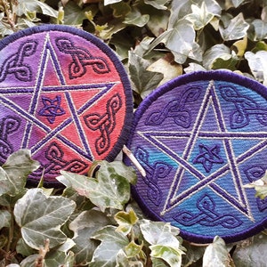 May include: Two circular embroidered patches featuring a five-pointed star design. The star is outlined in white and the background is a gradient of purple, blue, and red.
