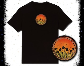 May include: Black t-shirt with a circular patch featuring a sunset with silhouettes of flowers. The patch is on the left side of the chest. A second patch is shown separately, featuring the same design.