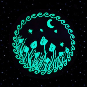 May include: A glowing green and white illustration of mushrooms and a crescent moon in a dark blue night sky with stars. The illustration is surrounded by a white wavy border.