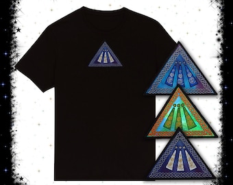 May include: A black t-shirt with a blue, green, and orange triangular design on the front. The design features a Celtic knot pattern and three stylized circles.