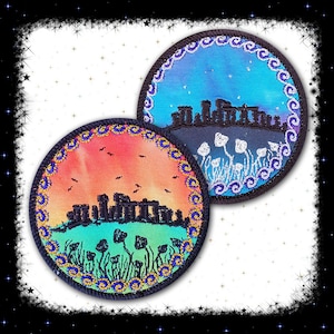 May include: Two round embroidered patches featuring a black silhouette of Stonehenge and a field of mushrooms. One patch has a blue and purple sky with white stars, the other has an orange and pink sunset.