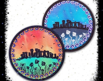 May include: Two round embroidered patches with a black silhouette of Stonehenge and a field of mushrooms. One patch has a blue and purple sky with white stars, the other has an orange and pink sunset.