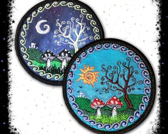 May include: Two embroidered patches with a circular design. The first patch features a white tree with a crescent moon and stars on a dark blue background. The second patch features a brown tree with a yellow sun on a light blue background. Both patches have a green border with a white swirl design.