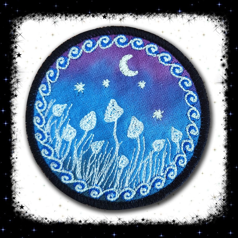 May include: A round embroidered patch with a blue and purple gradient background. The patch features a crescent moon, stars, and white mushrooms in a field of grass. The border of the patch is a black circle with a white, swirling design.