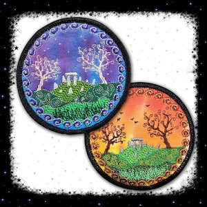 May include: Two round embroidered patches featuring a nature scene. The first patch has a purple and blue background with a white tree and a stone circle. The second patch has an orange and yellow background with a brown tree and a stone circle.
