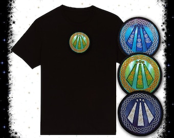 May include: A black t-shirt with a green, blue, and gold circular patch on the front. Three additional patches are shown below the t-shirt, each with a different color scheme: blue, green, and purple.