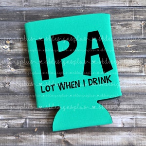 May include: A teal beer can cooler with the words "IPA" in large black letters, and the phrase "LOT WHEN I DRINK" below. The background is a weathered wooden surface.