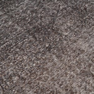 May include: A close-up of a gray and white patterned rug with a textured surface.