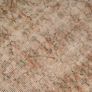 May include: Close-up of a vintage rug with a detailed, woven pattern. The rug features a beige background with intricate designs in shades of brown, green, and rust. The texture appears soft and well-worn.
