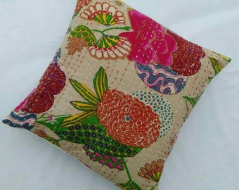 May include: A beige cotton pillow cover with a floral pattern in shades of pink, red, green, and yellow. The pillow cover is quilted and has a subtle sheen.