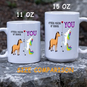 May include: Two white ceramic mugs with a unicorn and horse graphic. The text on the mugs reads "Other maids of honor" and "You". The mugs are shown side-by-side to illustrate the size difference. The smaller mug is 11 oz and the larger mug is 15 oz.