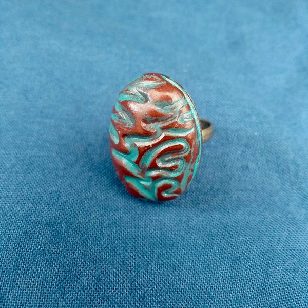 Bague ovale, collection "Rebecca" en pâte polymère, couleurs bronze et turquoise montée sur anneau couleur bronze