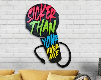 May include: A black wooden wall art piece in the shape of a microphone. The words "SICKER THAN YOUR AVERAGE" are written in colorful, graffiti-style lettering. The art is mounted on a white brick wall.