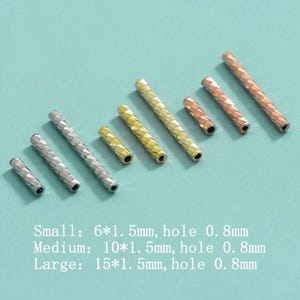 May include: An assortment of metallic tube beads in silver, gold, copper, and rose gold. The beads have a textured, diamond-like pattern. Sizes include small (6mm), medium (10mm), and large (15mm), with a 0.8mm hole.