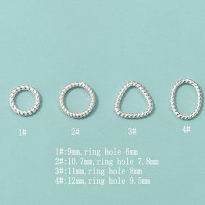 May include: Four silver-colored rings with a twisted rope design. The rings are in different shapes: round, a triangle, and an oval. Text below the rings indicates the ring and ring hole sizes in millimeters.