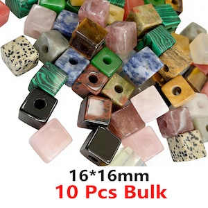May include: A selection of colourful gemstone cube beads, each measuring approximately 1.6cm x 1.6cm, with a hole for threading. The beads are in shades of pink, green, black, and brown. The image includes the text "16*16mm 10 Pcs Bulk".