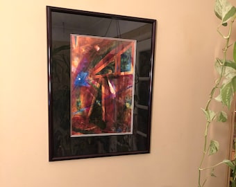 May include: A framed abstract painting with a black frame and a colorful abstract design. The painting is hanging on a wall next to a black and gold vase.