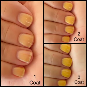 May include: Close-up of fingernails with yellow nail polish. The image shows the nail polish after one, two, and three coats. The text "1 Coat", "2 Coat", and "3 Coat" is visible in the image.