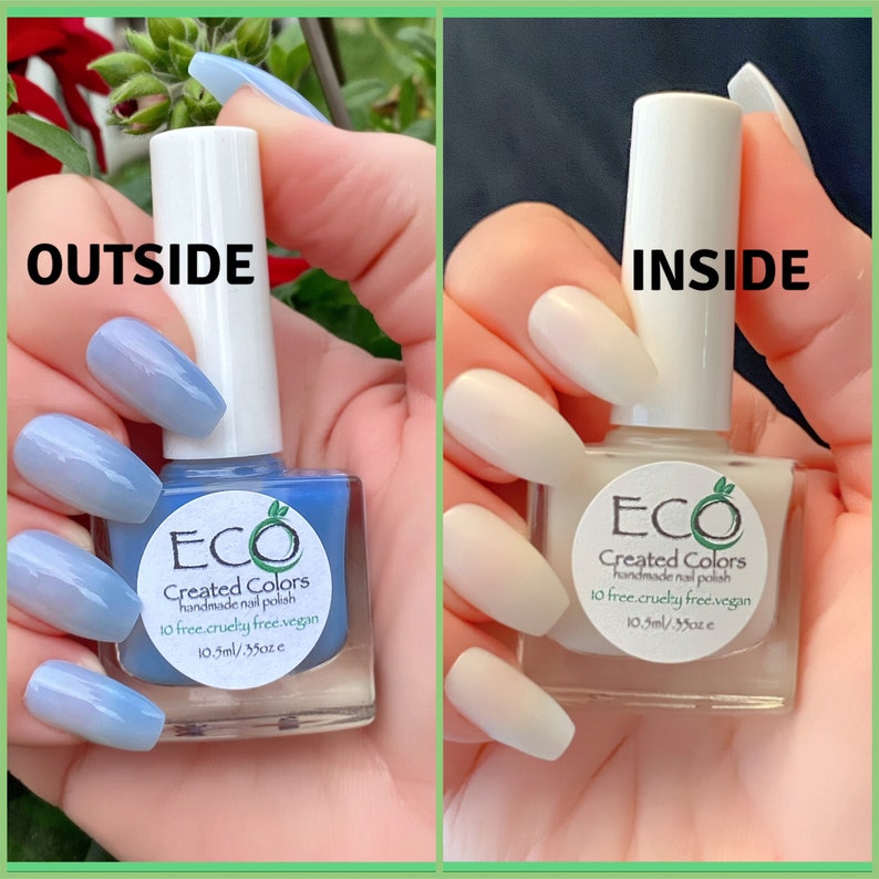 May include: Two bottles of nail polish, one light blue and one white, with the label "ECO Created Colors handmade nail polish 10 free cruelty free vegan 10.5ml/35oz e" on each bottle.