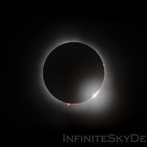 May include: A total solar eclipse, with the sun's corona visible as a bright ring around the moon.