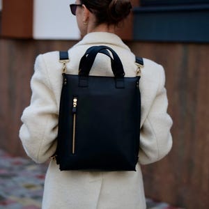 May include: A set of three ceramic mugs with a speckled, matte finish. The mugs are in shades of cream, light gray, and dark gray. Each mug has a simple, minimalist design, perfect for coffee or tea.