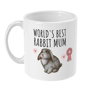 Peut inclure: Mug en céramique blanche avec une illustration en noir et blanc d'un lapin et le texte "World's Best Rabbit Mum".
