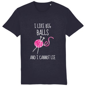 May include: Navy blue t-shirt with a white graphic of a pink ball of yarn and knitting needles. The text "I like big balls and I cannot lie" is printed on the shirt.