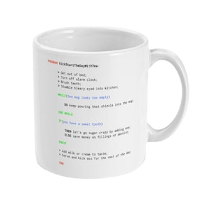 May include: White ceramic mug with a black and green design. The mug features a humorous program-like list of steps to start the day with tea, including "Get out of bed", "Turn off alarm clock", "Brush teeth", and "Stumble bleary eyed into kitchen".