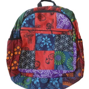 May include: A multi-coloured patchwork backpack with a black zipper and a front pocket. The backpack features a variety of patterns, including mushrooms, flowers, and geometric designs.