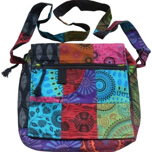 May include: A colourful patchwork shoulder bag with a long adjustable strap. The bag is made of different fabrics with geometric and floral patterns in shades of blue, green, red, purple, and black.