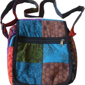 May include: A patchwork style shoulder bag with a black strap and a zipped pocket. The bag is made of colourful fabric with different patterns.