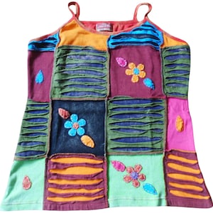 May include: A multi-coloured patchwork tank top with a variety of floral embroidery. The top is made of different fabrics and has a distressed look.