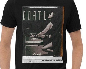 May include: Black t-shirt with a graphic print of a woman playing a guitar in front of a Marshall amplifier. The graphic is in a vintage style with a faded look and the text "COATL LOS ANGELES, CALIFORNIA".