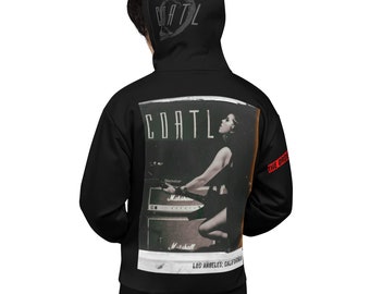 May include: Black hoodie with a graphic print of a woman playing a guitar in front of a Marshall amplifier. The text "COATL" is printed on the hoodie. The text "THE ORDER" is printed on the sleeve.