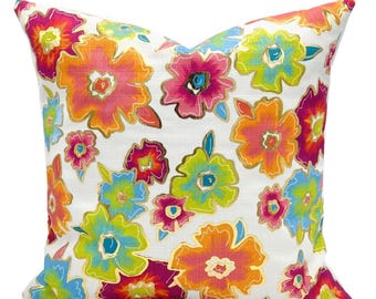 May include: A white pillow with a colorful floral pattern. The flowers are pink, orange, yellow, green, and blue. The flowers have gold outlines.