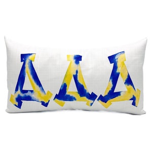 May include: A white pillow with the letters "AAA" in blue and yellow watercolor.