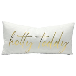 May include: White rectangular pillow with the words "hotty toddy" written in gold script.