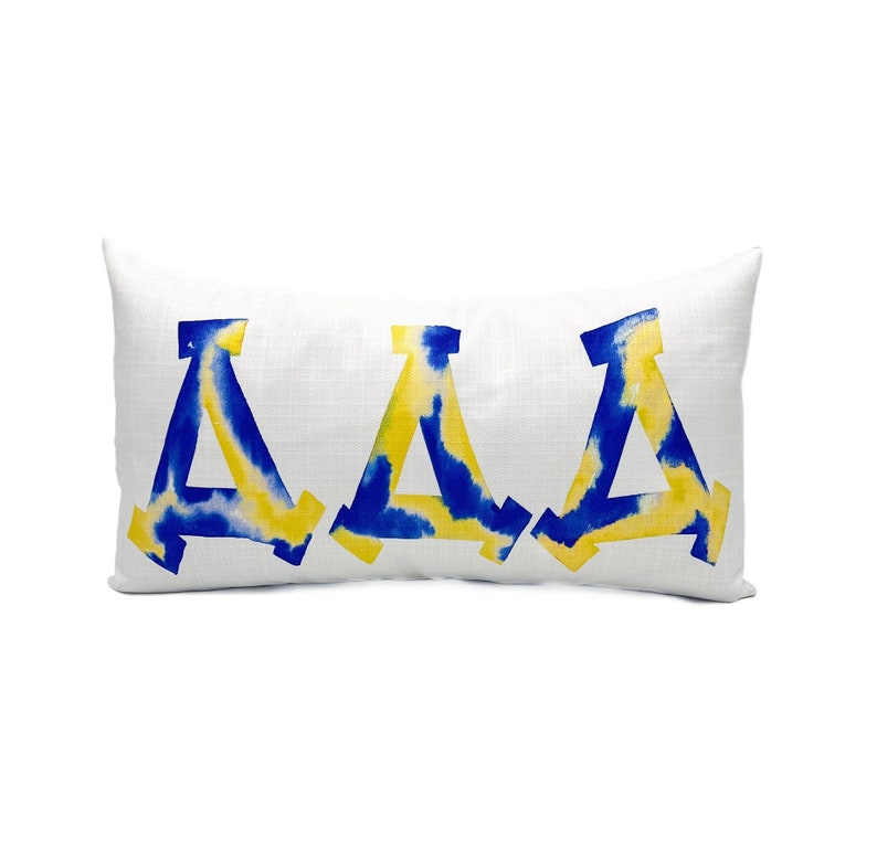 May include: A white pillow with the letters "AAA" in blue and yellow watercolor.
