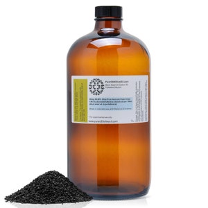 May include: A 1-liter amber glass bottle of Pure C60 Olive Oil Black Seed Oil Carbon 60 Fullerene Solution. The bottle has a white label with the product name and description. A small pile of black seeds is in the foreground.