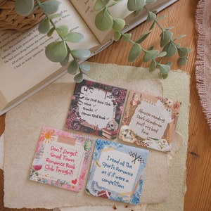May include: A selection of square cards with handwritten text and decorative elements. The cards feature phrases such as "For PIVR Book Club," "Don't forget: Small Town Romance Book Club tonight!" and "I read all the Sports Romance as if it were a competition."