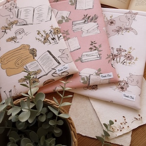 May include: Three book sleeves with a floral and book pattern. The sleeves are in pink, white, and cream colors. The sleeves have the text "Book Chic" printed on them.