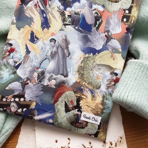 May include: A colorful book cover with a watercolor design featuring characters and creatures from the Harry Potter series. The cover includes a phoenix, a dragon, a basilisk, and other magical creatures. The text "Book Chic" is printed on a white label in the lower right corner.