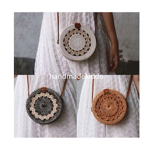 May include: Three round woven rattan bags with leather straps. The bags are white, black and brown.