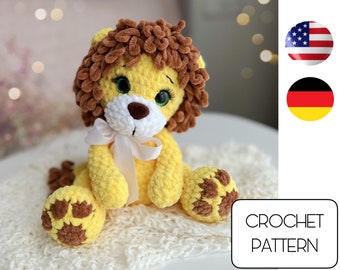 May include: Crochet pattern for a yellow lion amigurumi toy with brown fur and white facial features. The lion is sitting on a white crocheted blanket.