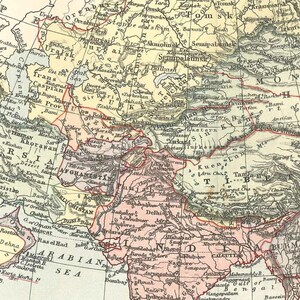 May include: An antique map of Asia, showing countries such as Persia, Afghanistan, and India. The map is coloured in beige, yellow, and pink, with red lines indicating borders and rivers. The text includes place names and geographical features.