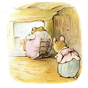 May include: An illustration depicts a frog in a pink dress sitting in a rocking chair, facing a window. A mouse in a bonnet and dress stands nearby. The scene is set inside a rustic, wooden-walled room.