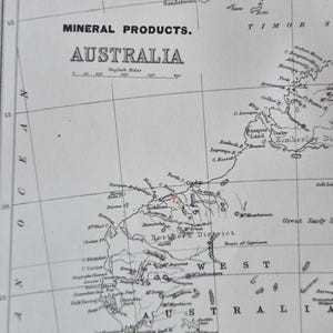 May include: A detailed vintage map of Australia, labelled "Mineral Products." The map shows geographical features, cities, and the surrounding islands. The scale is in English miles. The map is in black and white.