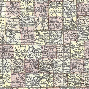 May include: A detailed vintage map of Iowa, USA, with a network of roads and labeled cities. The map features a grid pattern with pink and yellow hues, showcasing towns like Waterloo and Des Moines.