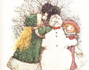 May include: An illustration of two children building a snowman in a winter scene. The snowman has a red bow tie and black button eyes. The children are wearing winter clothing, including hats and coats. The word "Winter" is at the top.